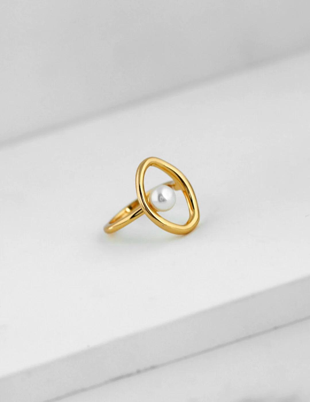 A beautifully handcrafted Geometric Open Circle Ring featuring natural pearls and sterling silver with gold vermeil plating.