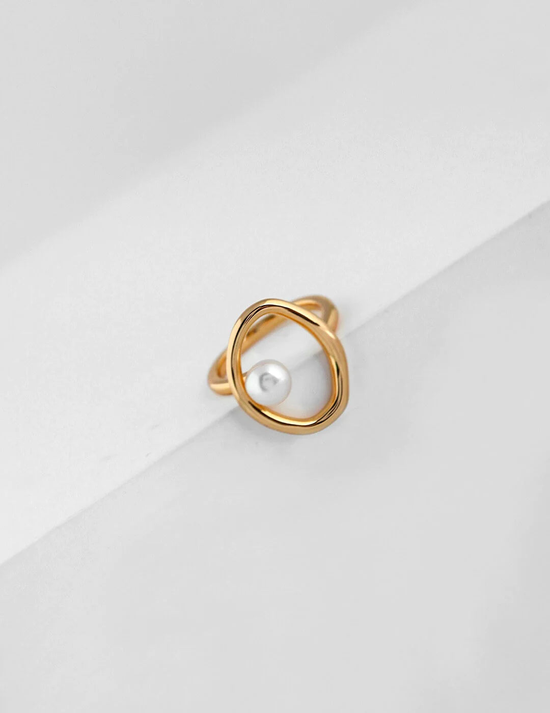 A beautifully handcrafted Geometric Open Circle Ring featuring natural pearls and sterling silver with gold vermeil plating.