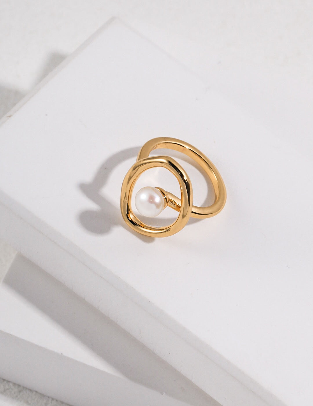 A beautifully handcrafted Geometric Open Circle Ring featuring natural pearls and sterling silver with gold vermeil plating.