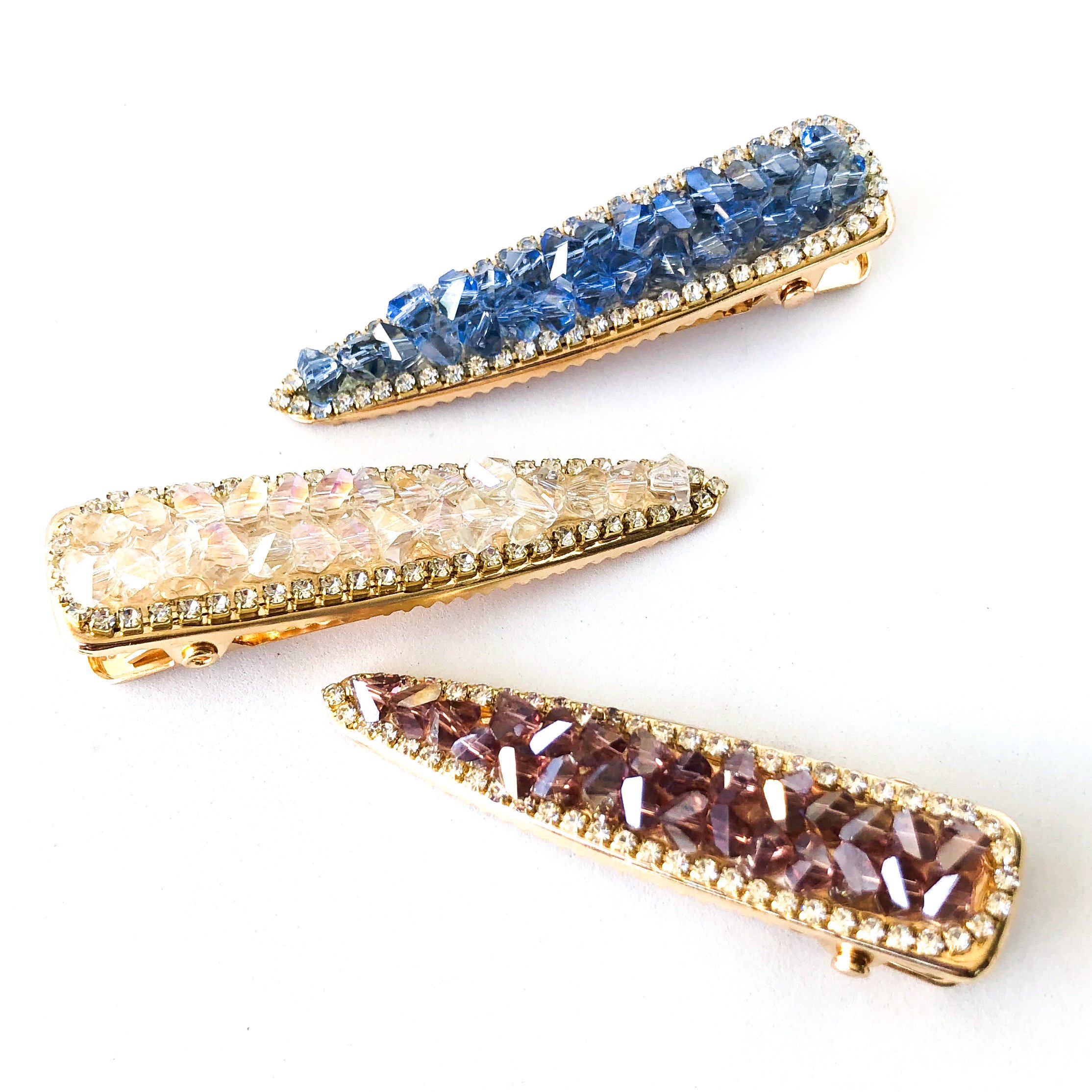 Georgie Barrette featuring sparkling white, blue, and violet crystals encrusted with rhinestones, perfect for elegant hairstyles.