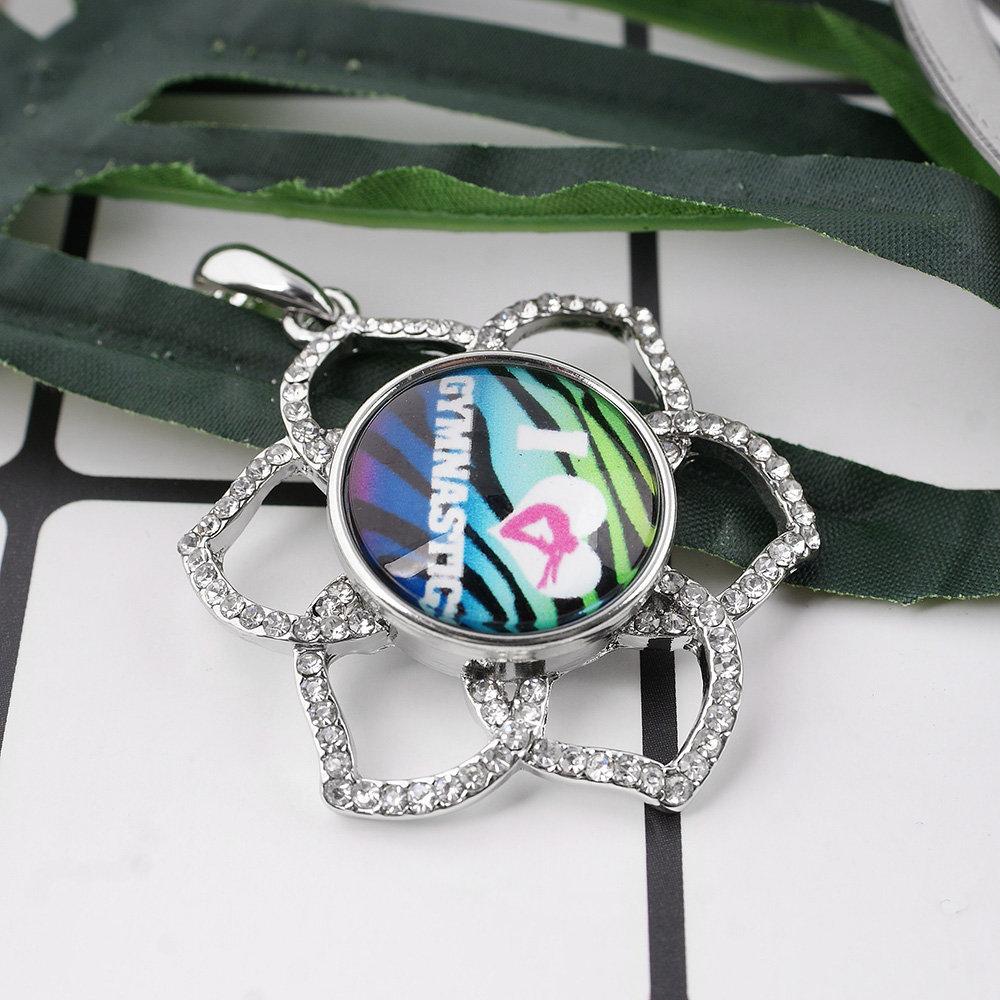 A vibrant 'I Love Gymnastics' glass domed snap, showcasing a colorful design perfect for interchangeable jewelry.