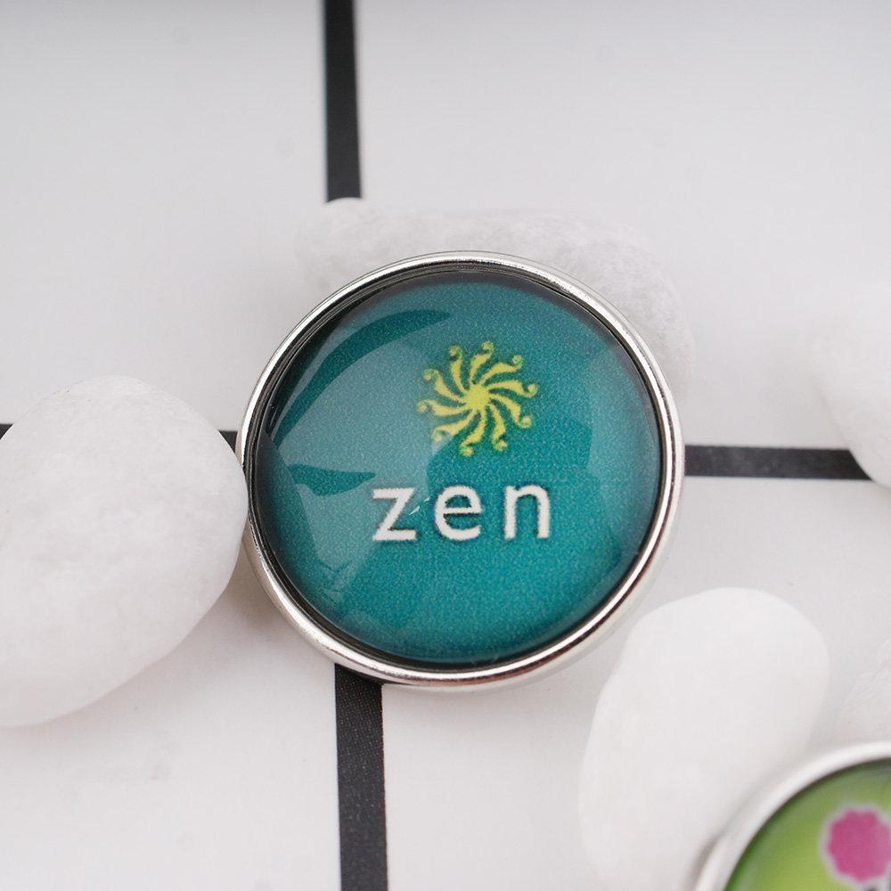 Zen Snap jewelry charm with a glass dome, showcasing intricate design and vibrant colors, perfect for interchangeable snap jewelry.