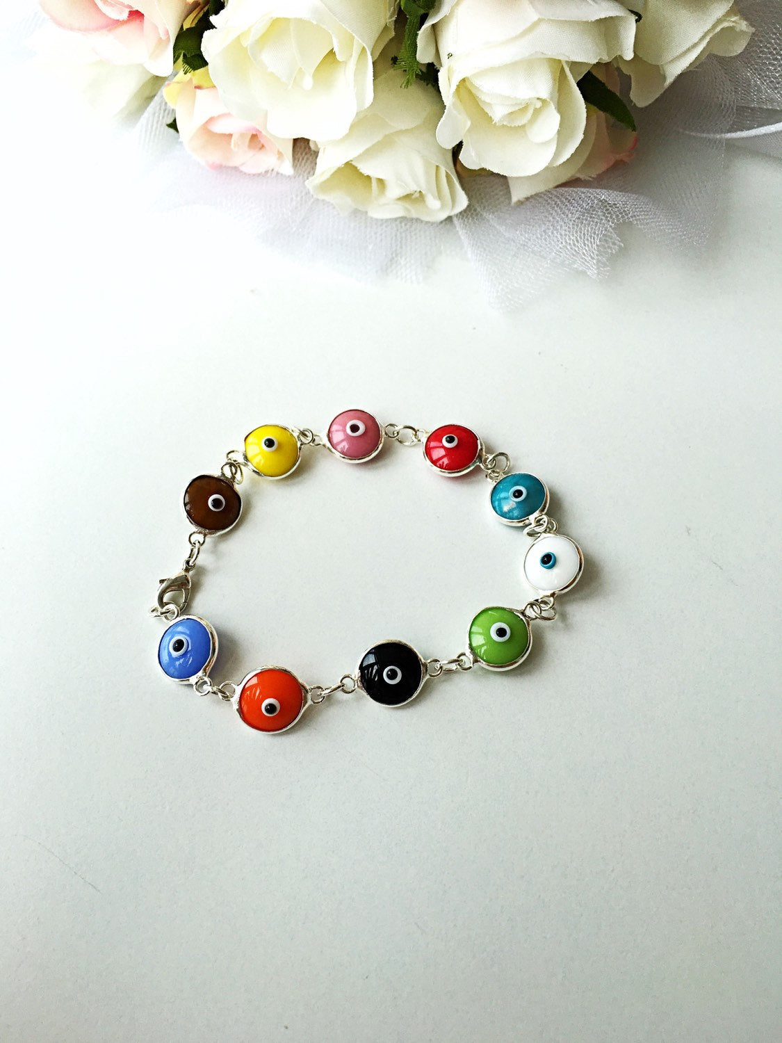 Colorful Glass Evil Eye Bracelet featuring vibrant charms on a durable Murano chain, perfect for protection and style.