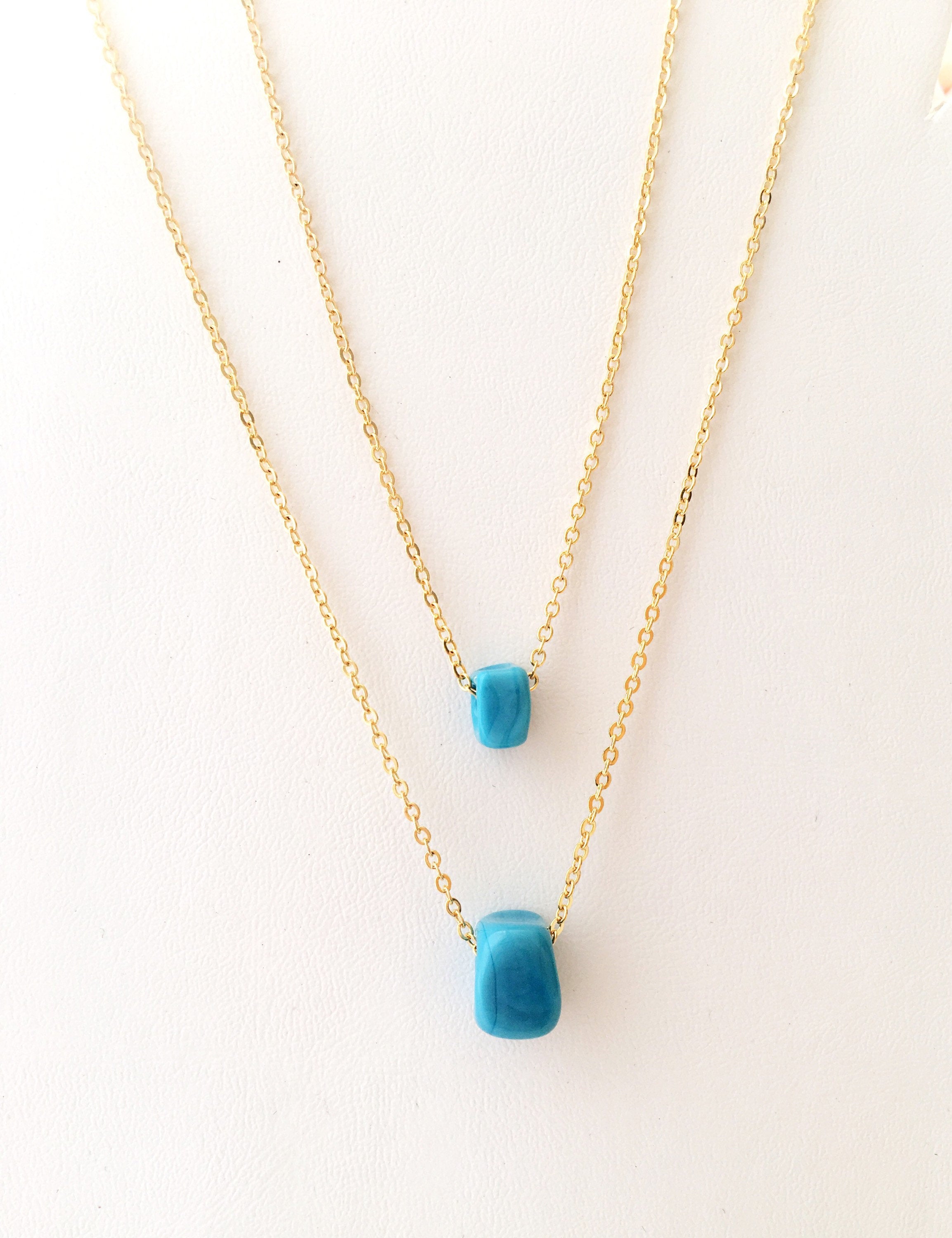 Handmade Glass Turquoise charm necklace featuring dreadlock glass beads and a stainless steel chain in gold and silver options.