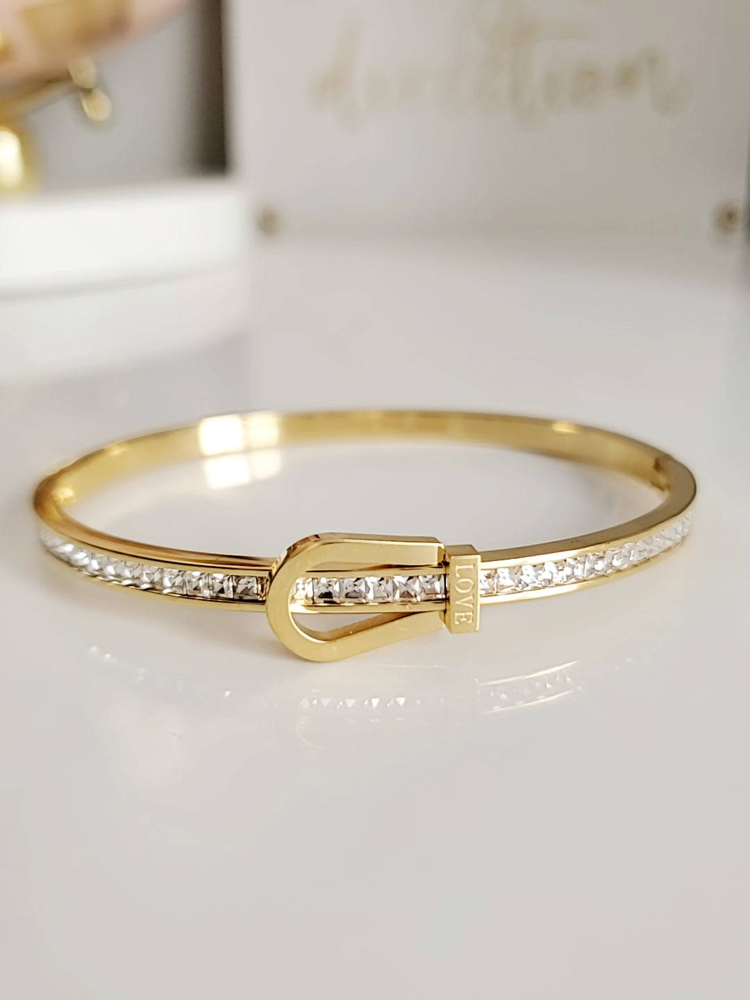 Elegant Gold Belt Bangle made of 316L stainless steel with simulated diamonds, featuring a unique belt design and snap-on closure.