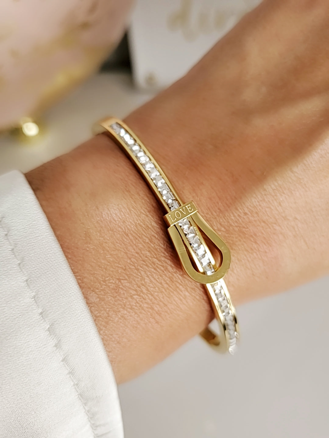 Elegant Gold Belt Bangle made of 316L stainless steel with simulated diamonds, featuring a unique belt design and snap-on closure.