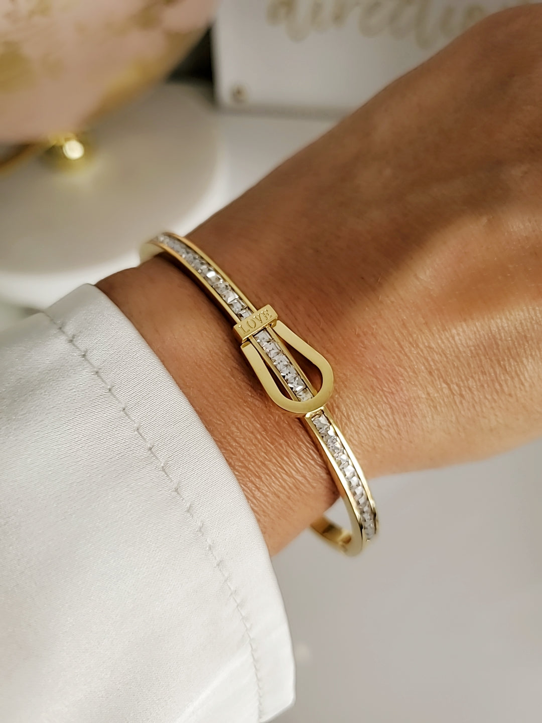 Elegant Gold Belt Bangle made of 316L stainless steel with simulated diamonds, featuring a unique belt design and snap-on closure.