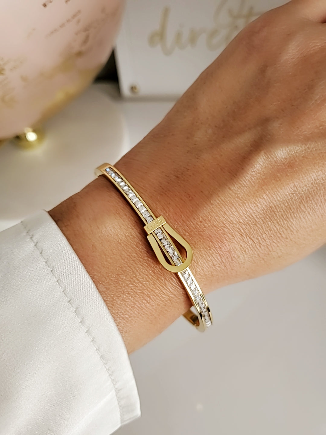 Elegant Gold Belt Bangle made of 316L stainless steel with simulated diamonds, featuring a unique belt design and snap-on closure.