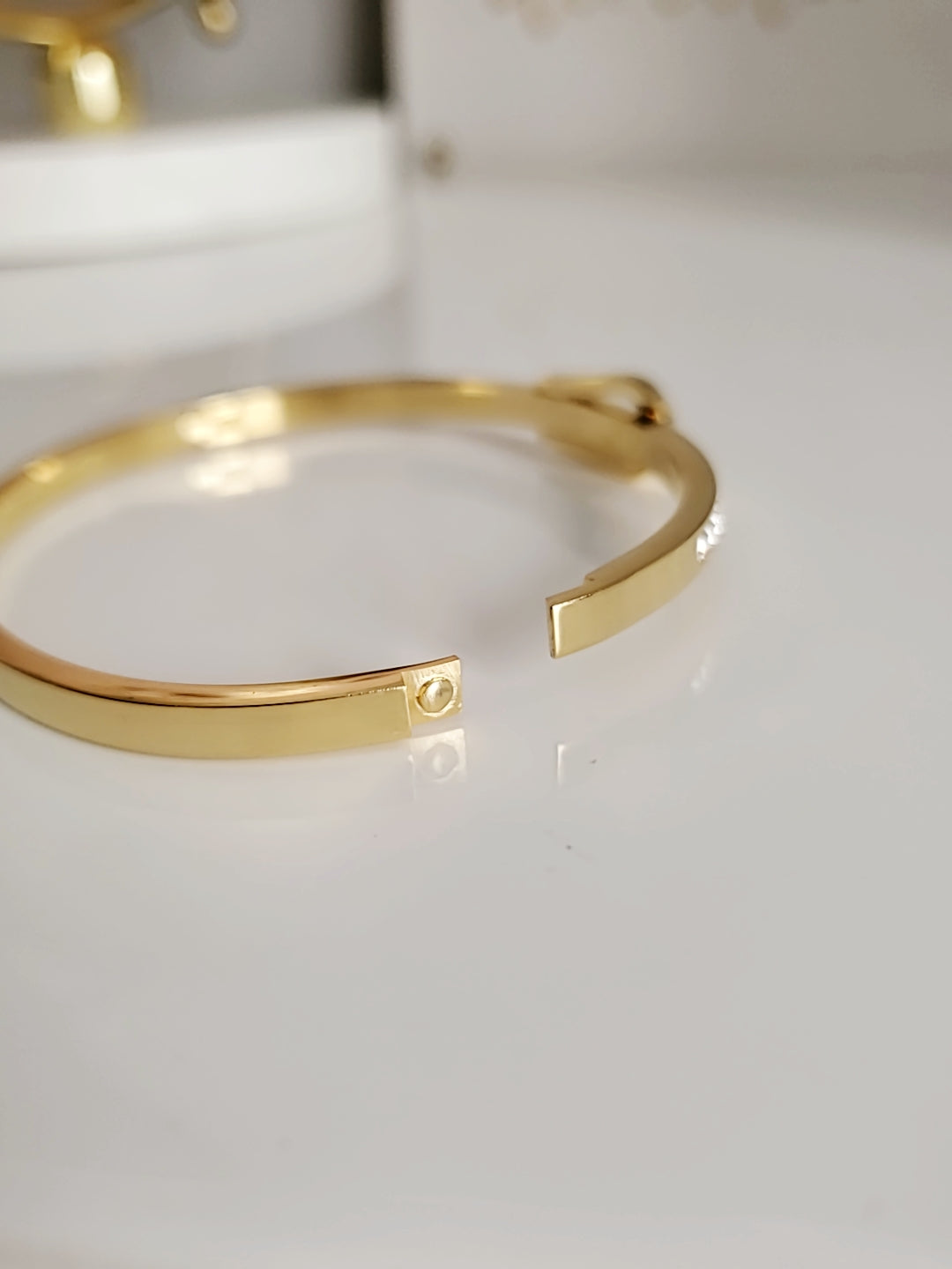 Elegant Gold Belt Bangle made of 316L stainless steel with simulated diamonds, featuring a unique belt design and snap-on closure.