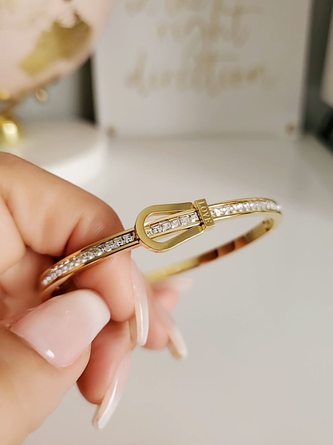 Elegant Gold Belt Bangle made of 316L stainless steel with simulated diamonds, featuring a unique belt design and snap-on closure.