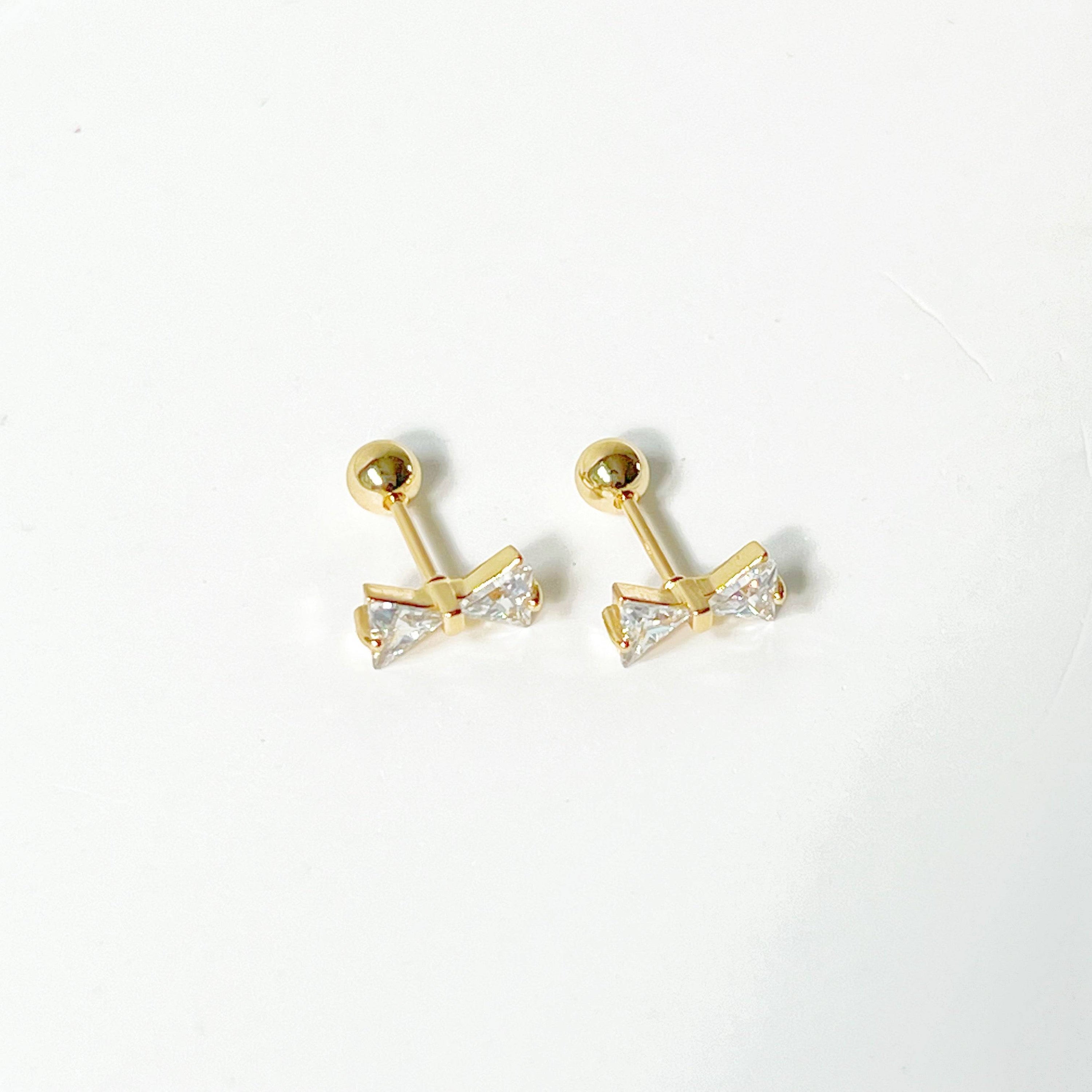 Gold Bow Zircon Earrings featuring a small bow design with clear zircon stones, set on a hypoallergenic surgical steel base.