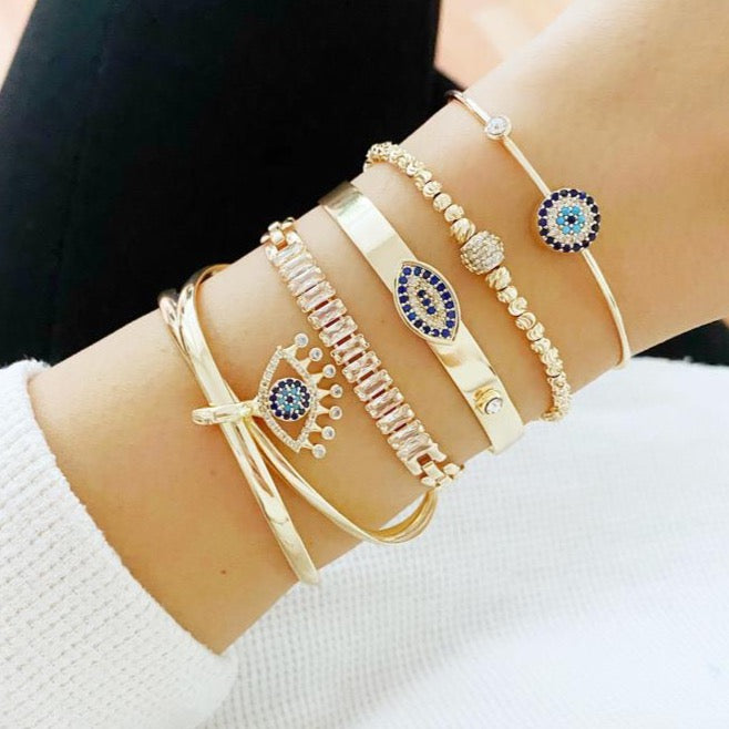 A beautiful Gold Bracelet Set featuring Evil Eye, Cuff, and CZ designs, showcasing intricate handmade craftsmanship.