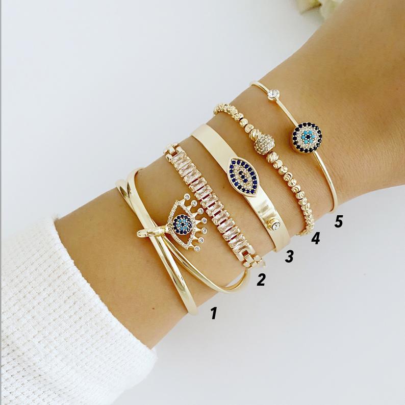 A beautiful Gold Bracelet Set featuring Evil Eye, Cuff, and CZ designs, showcasing intricate handmade craftsmanship.