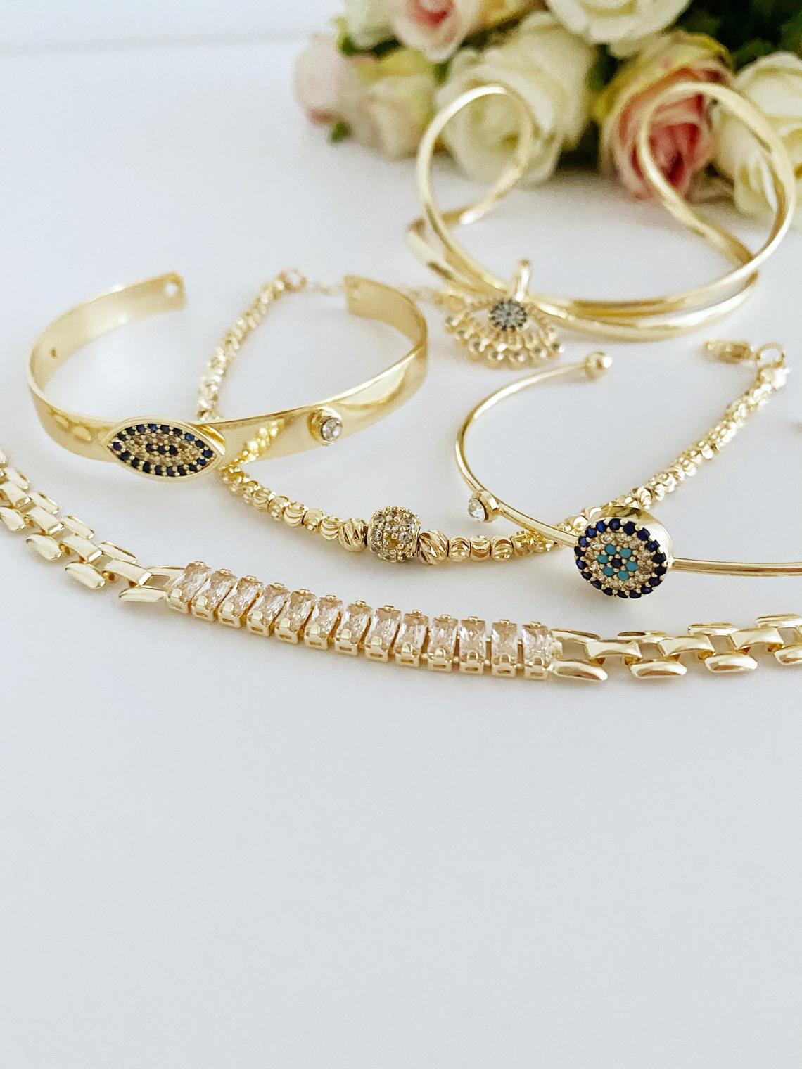 A beautiful Gold Bracelet Set featuring Evil Eye, Cuff, and CZ designs, showcasing intricate handmade craftsmanship.