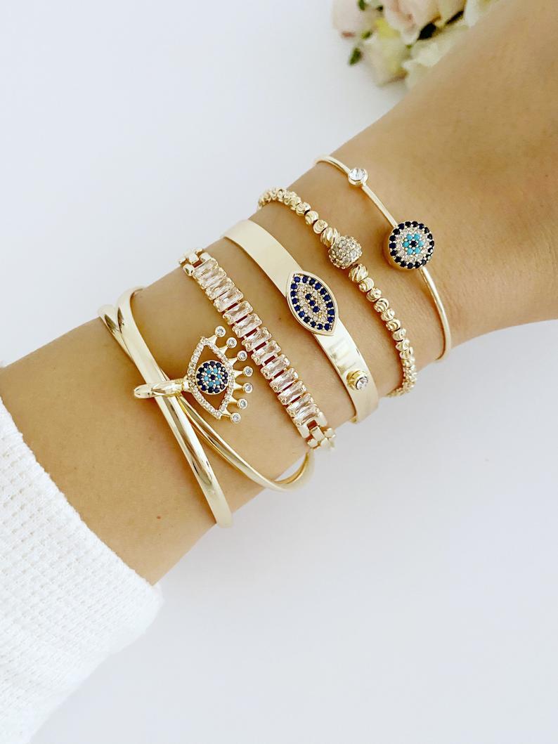 A beautiful Gold Bracelet Set featuring Evil Eye, Cuff, and CZ designs, showcasing intricate handmade craftsmanship.