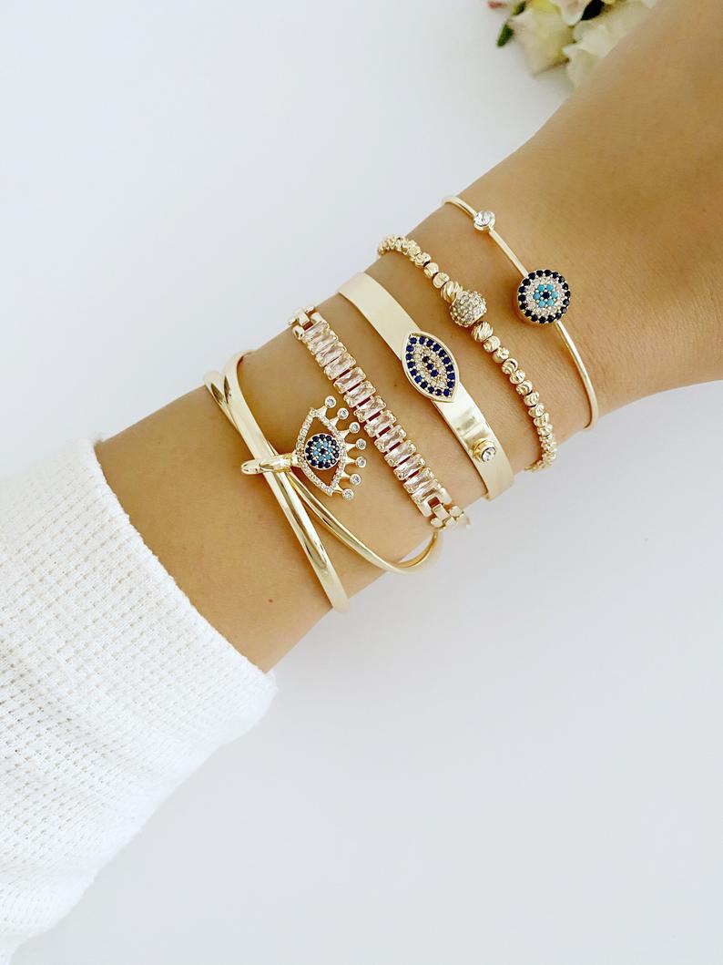 A beautiful Gold Bracelet Set featuring Evil Eye, Cuff, and CZ designs, showcasing intricate handmade craftsmanship.