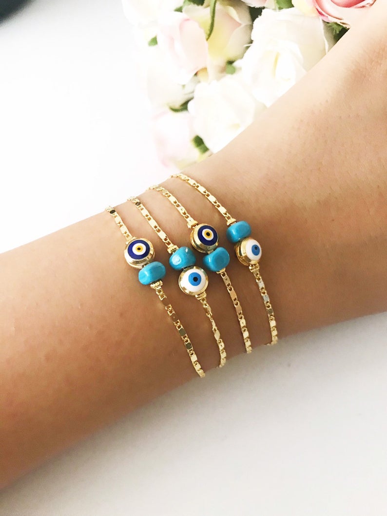 A beautiful gold chain bracelet featuring a blue and white evil eye bead, symbolizing protection and style, handmade with care.