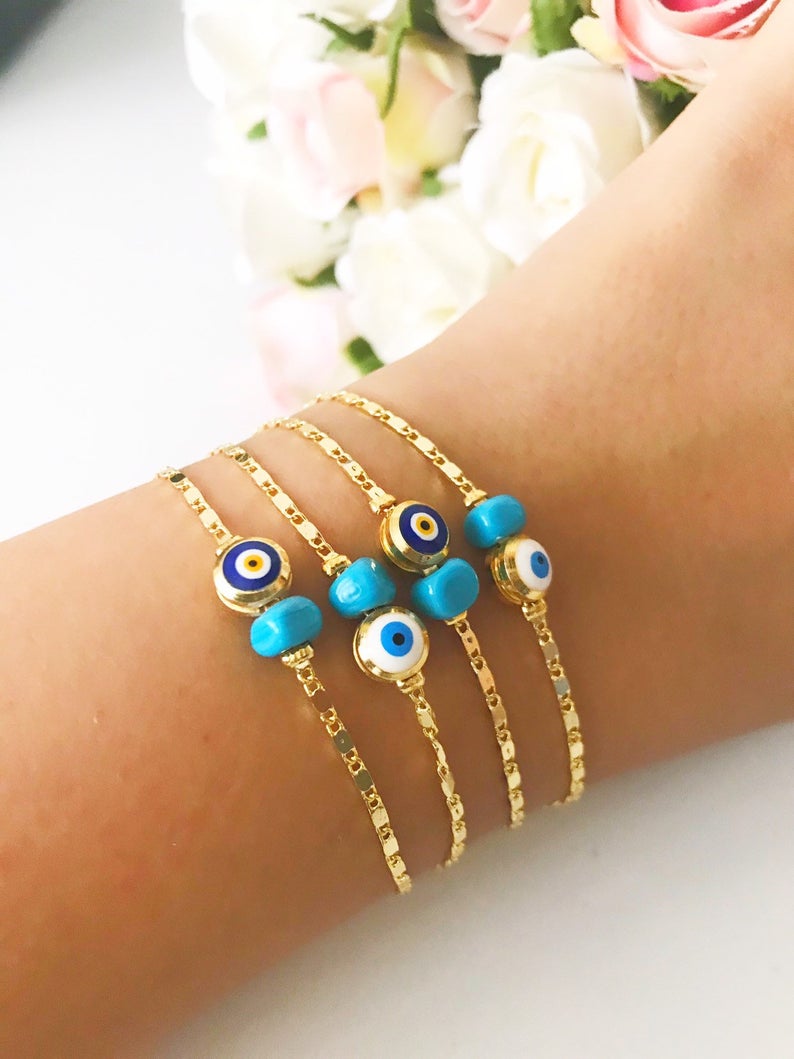 A beautiful gold chain bracelet featuring a blue and white evil eye bead, symbolizing protection and style, handmade with care.