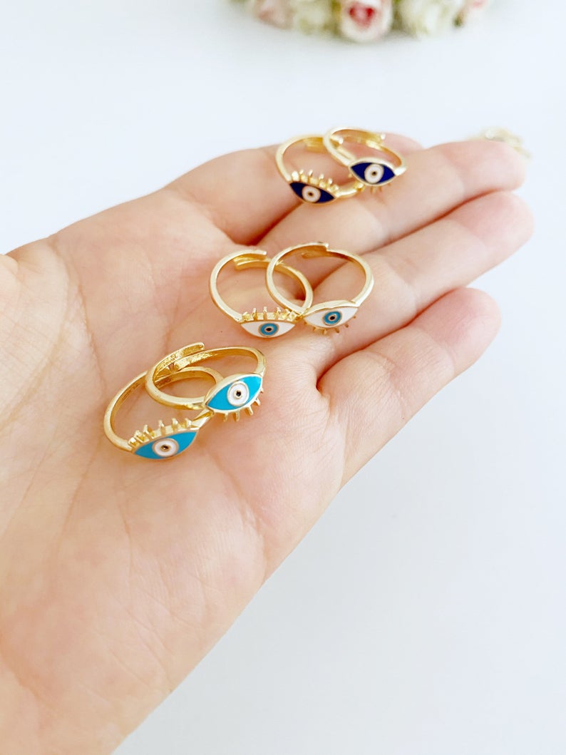 Gold Dainty Evil Eye Ring featuring a thin band and an oval evil eye charm in blue, turquoise, and white colors.