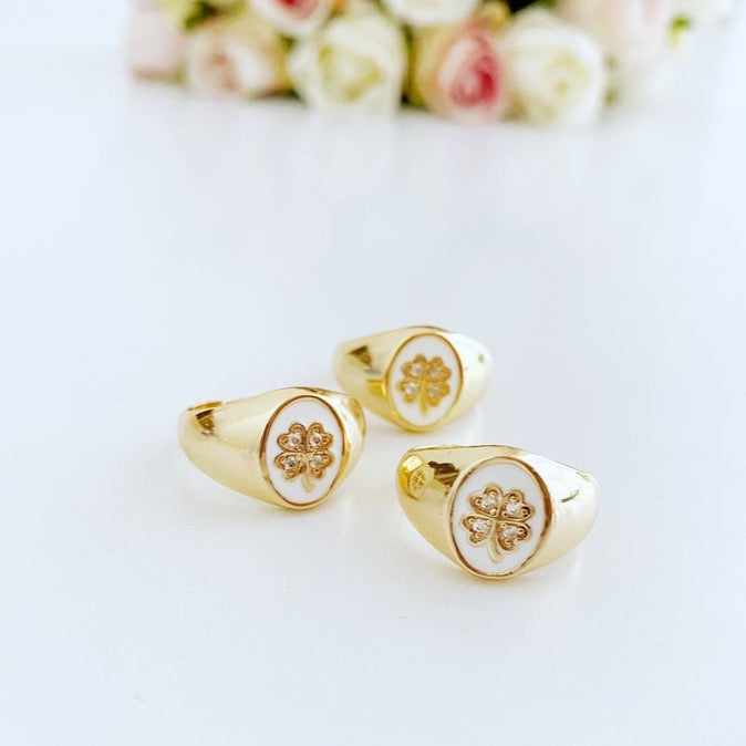 Gold Daisy Ring featuring a white clover charm, adjustable chunky design, perfect for stacking and good luck.