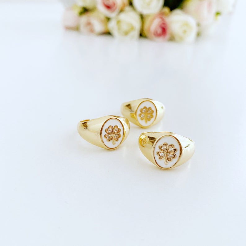 Gold Daisy Ring featuring a white clover charm, adjustable chunky design, perfect for stacking and good luck.