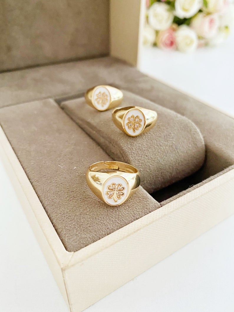 Gold Daisy Ring featuring a white clover charm, adjustable chunky design, perfect for stacking and good luck.