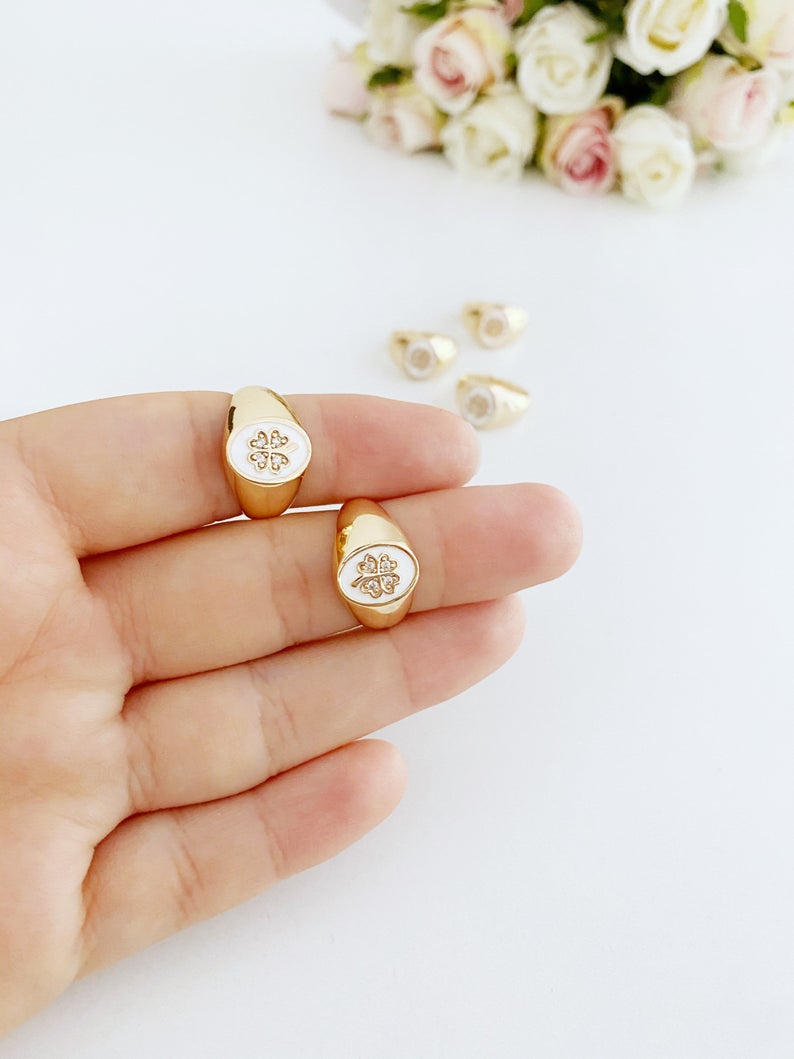 Gold Daisy Ring featuring a white clover charm, adjustable chunky design, perfect for stacking and good luck.