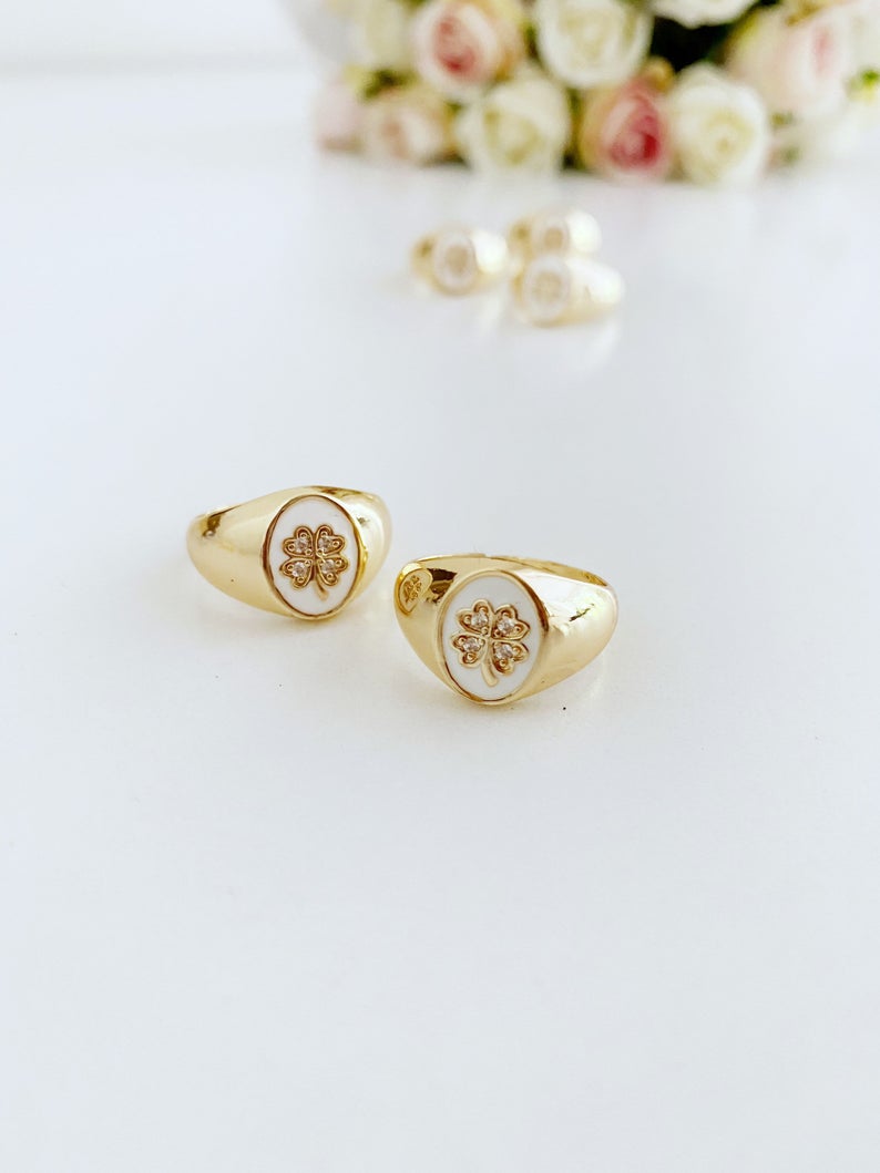 Gold Daisy Ring featuring a white clover charm, adjustable chunky design, perfect for stacking and good luck.