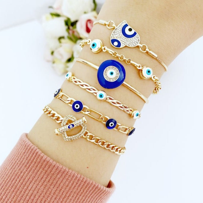 Gold Evil Eye Bracelet featuring a blue charm, adjustable stainless steel cuff design, perfect for everyday wear.