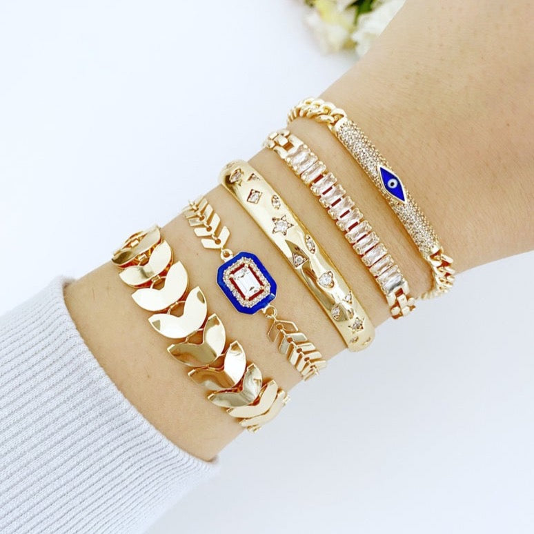 Gold Evil Eye Bracelet featuring a blue evil eye charm, crafted from durable stainless steel with a gold finish, adjustable design for all wrist sizes.