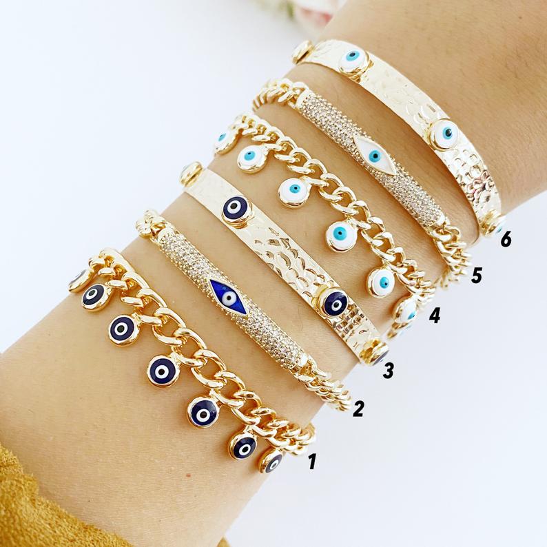 Gold Evil Eye Bracelet featuring blue and white evil eye bead, adjustable cuff design, handmade from tarnish-resistant stainless steel.