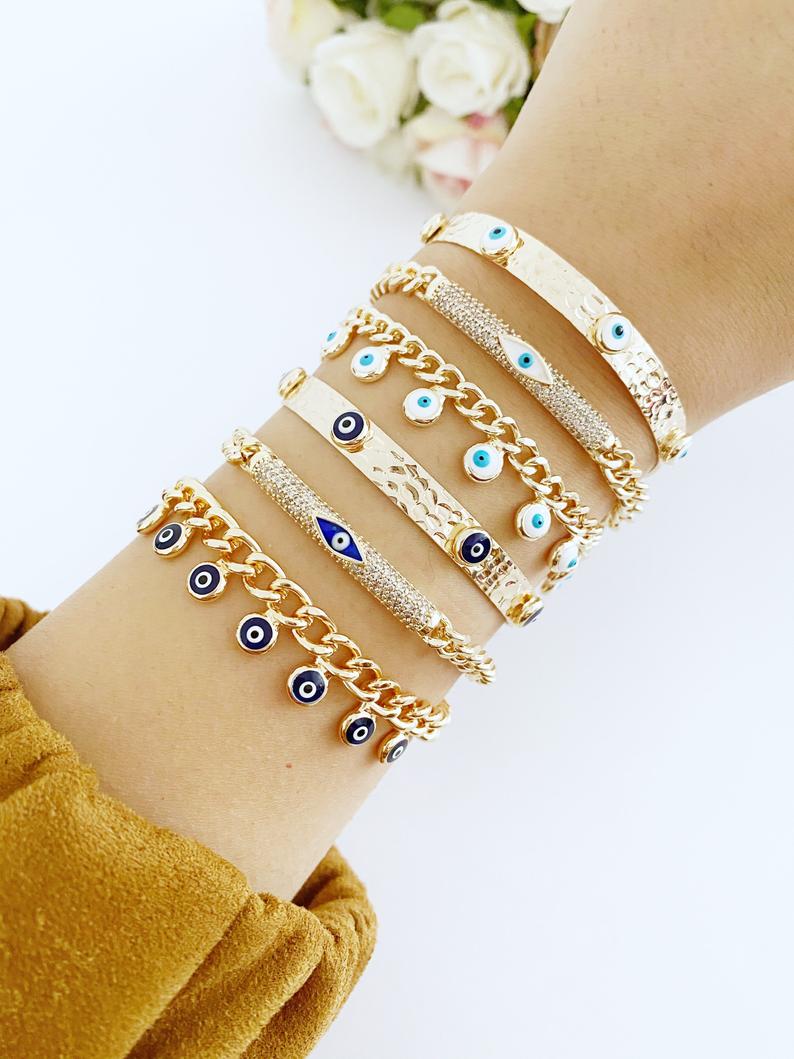 Gold Evil Eye Bracelet featuring blue and white evil eye bead, adjustable cuff design, handmade from tarnish-resistant stainless steel.