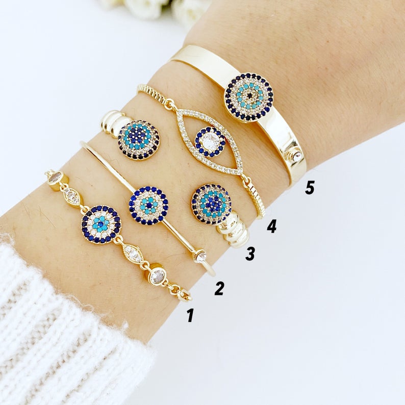 Gold Evil Eye Bracelet featuring a zircon evil eye bead, handmade with tarnish-resistant stainless steel, adjustable cuff design.