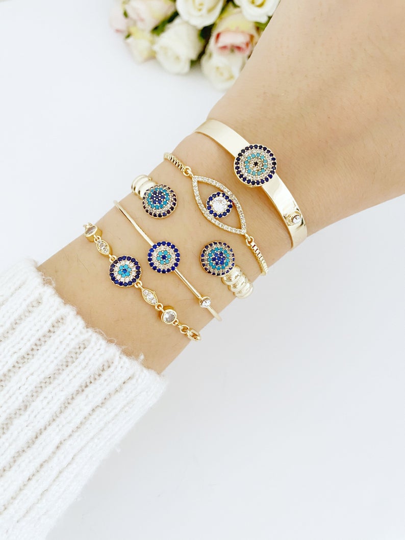 Gold Evil Eye Bracelet featuring a zircon evil eye bead, handmade with tarnish-resistant stainless steel, adjustable cuff design.