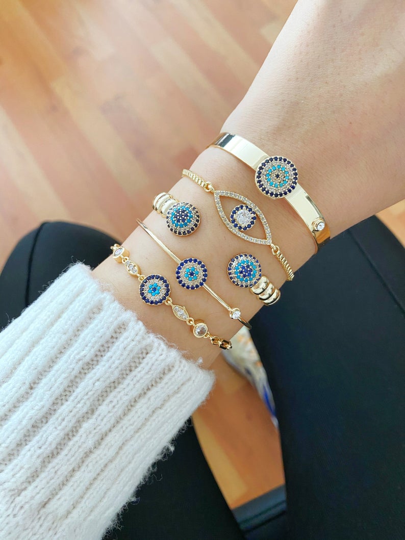 Gold Evil Eye Bracelet featuring a zircon evil eye bead, handmade with tarnish-resistant stainless steel, adjustable cuff design.