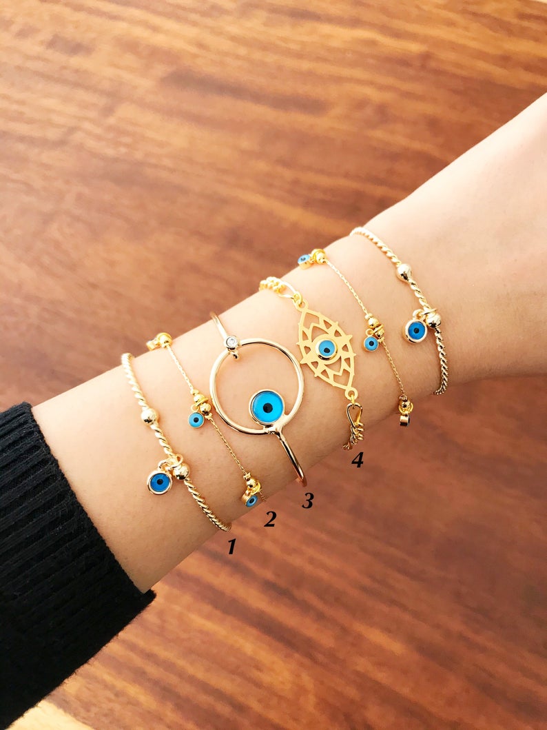 Gold Evil Eye Bracelet featuring a blue evil eye bead, handmade from tarnish-resistant stainless steel, adjustable for a perfect fit.