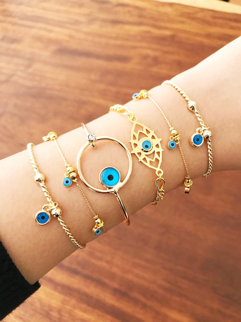 Gold Evil Eye Bracelet featuring a blue evil eye bead, handmade from tarnish-resistant stainless steel, adjustable for a perfect fit.