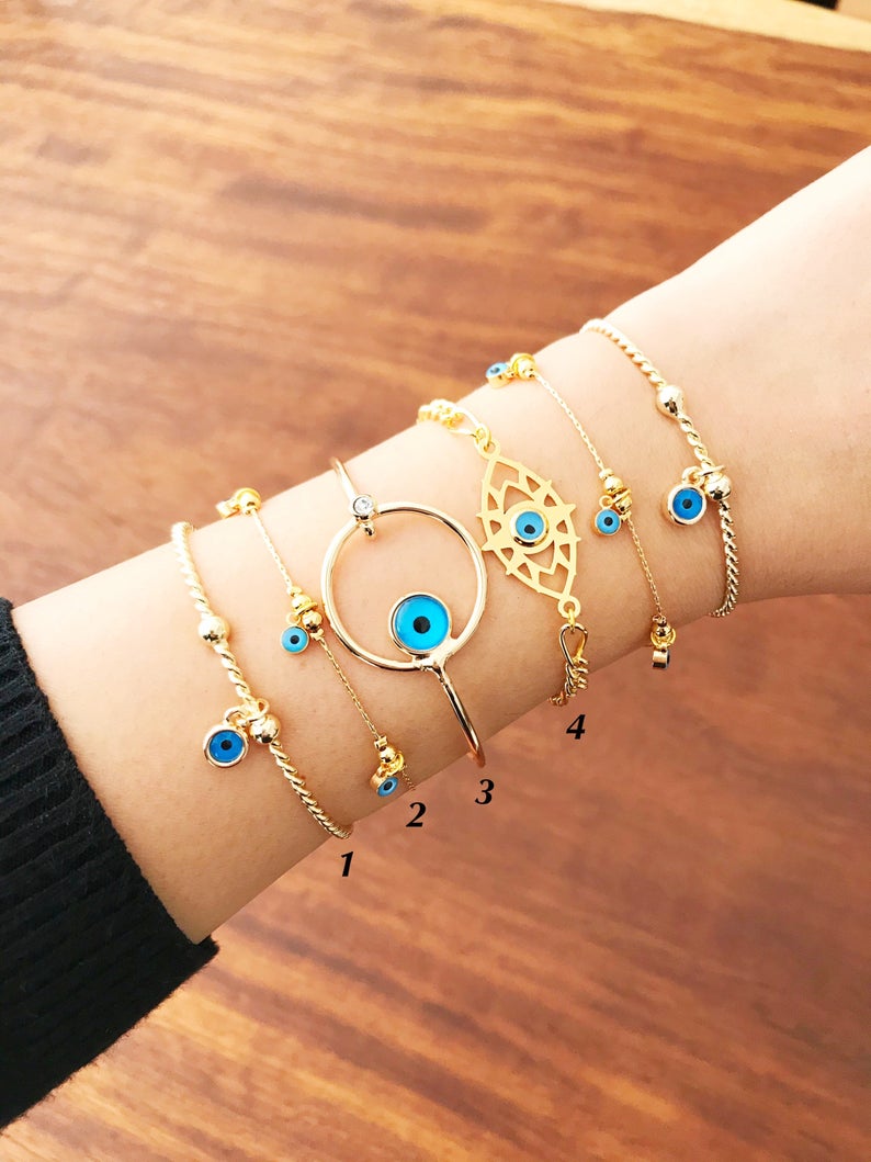 Gold Evil Eye Bracelet featuring a blue evil eye bead, handmade from tarnish-resistant stainless steel, adjustable for a perfect fit.