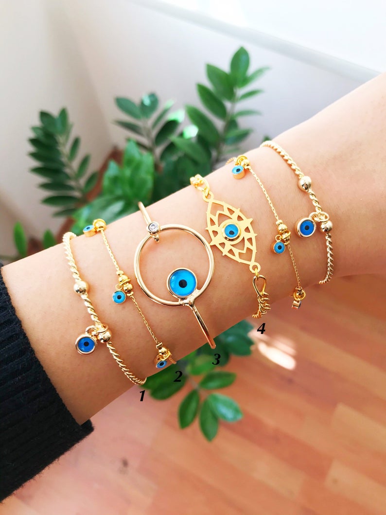 Gold Evil Eye Bracelet featuring a blue evil eye bead, handmade from tarnish-resistant stainless steel, adjustable for a perfect fit.