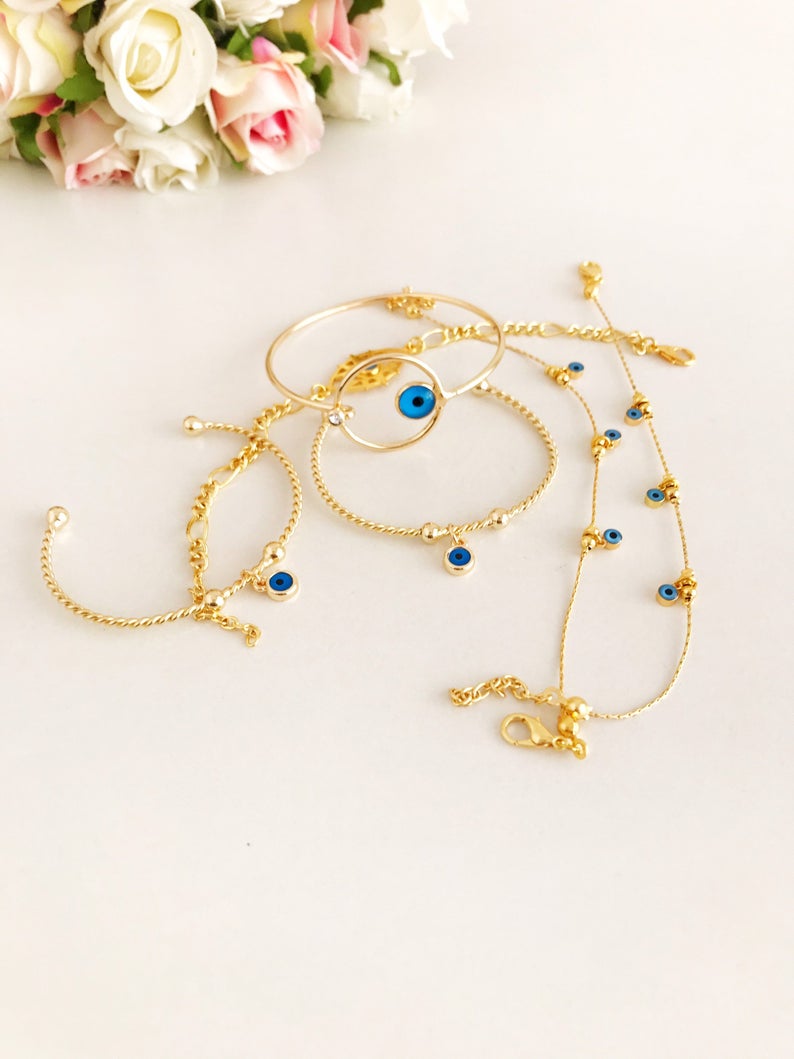 Gold Evil Eye Bracelet featuring a blue evil eye bead, handmade from tarnish-resistant stainless steel, adjustable for a perfect fit.