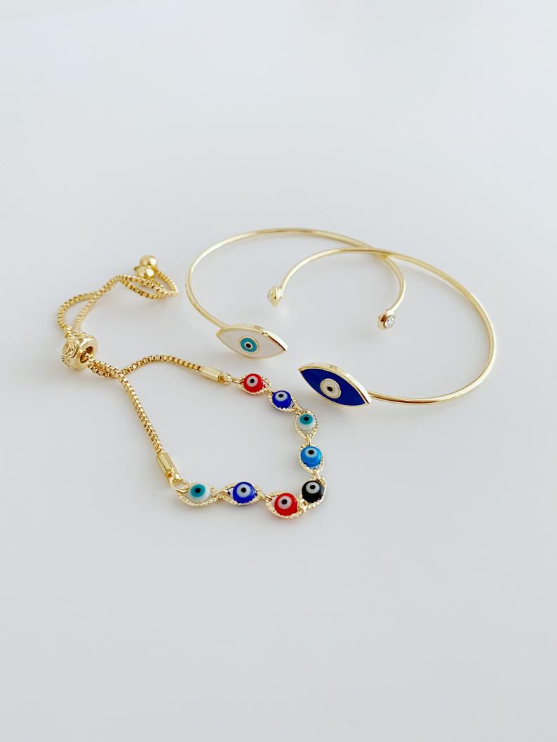 Gold Evil Eye Bracelet featuring multi-color beads and adjustable cuff design, handmade from tarnish-resistant stainless steel.