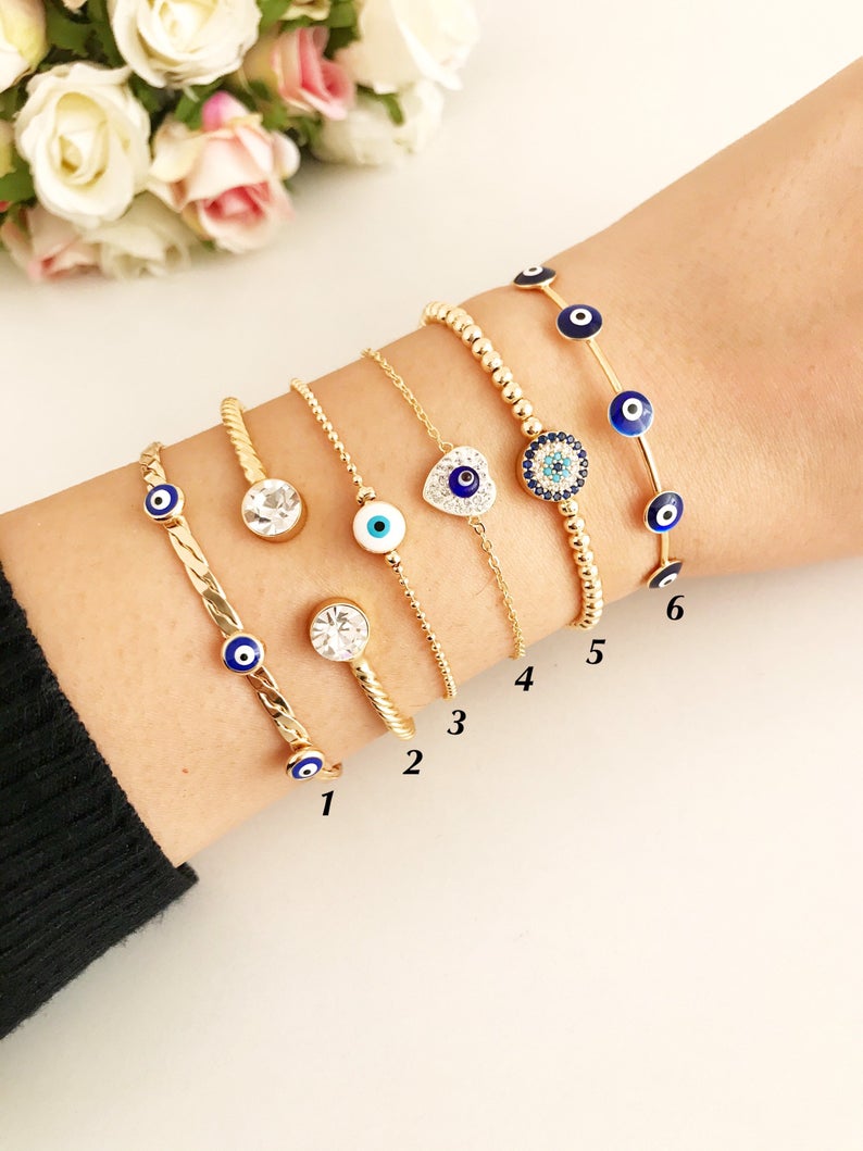 Gold Evil Eye Bracelet Set featuring adjustable bangles and cuffs with intricate designs, showcasing the protective evil eye symbol.