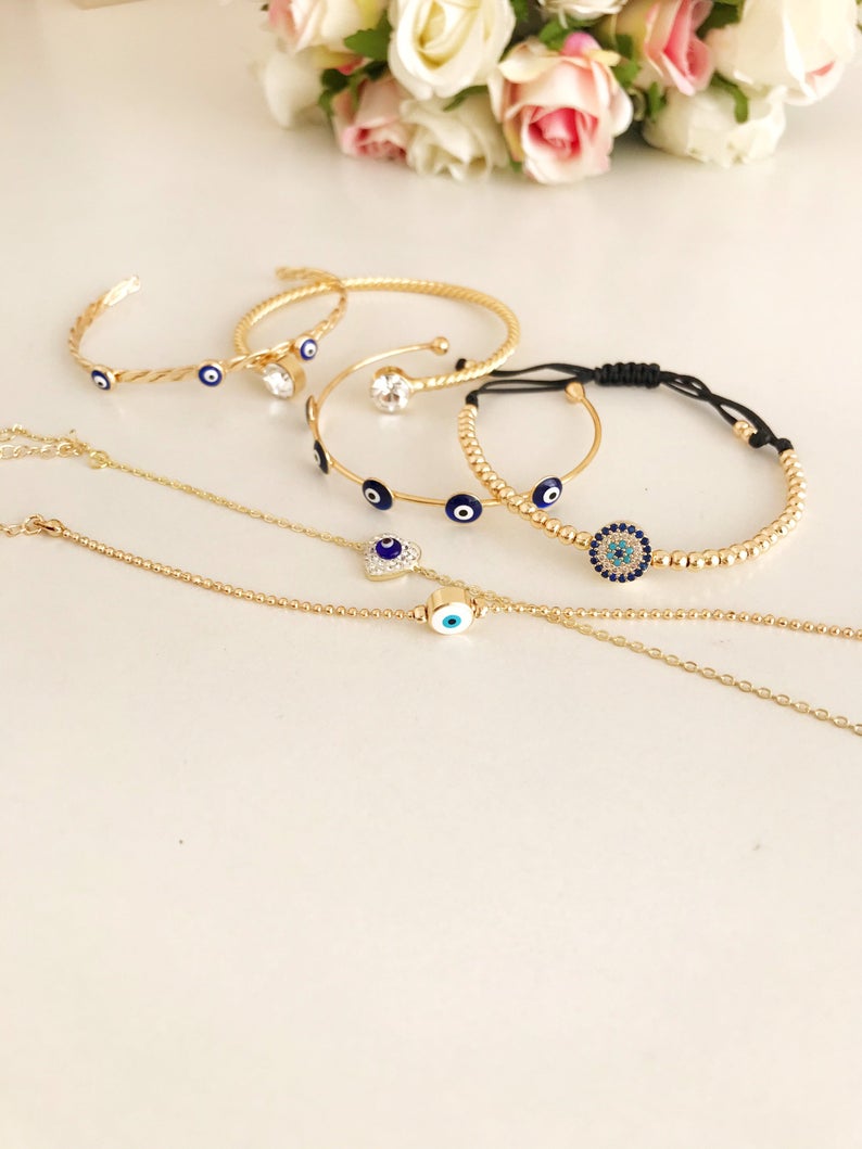 Gold Evil Eye Bracelet Set featuring adjustable bangles and cuffs with intricate designs, showcasing the protective evil eye symbol.