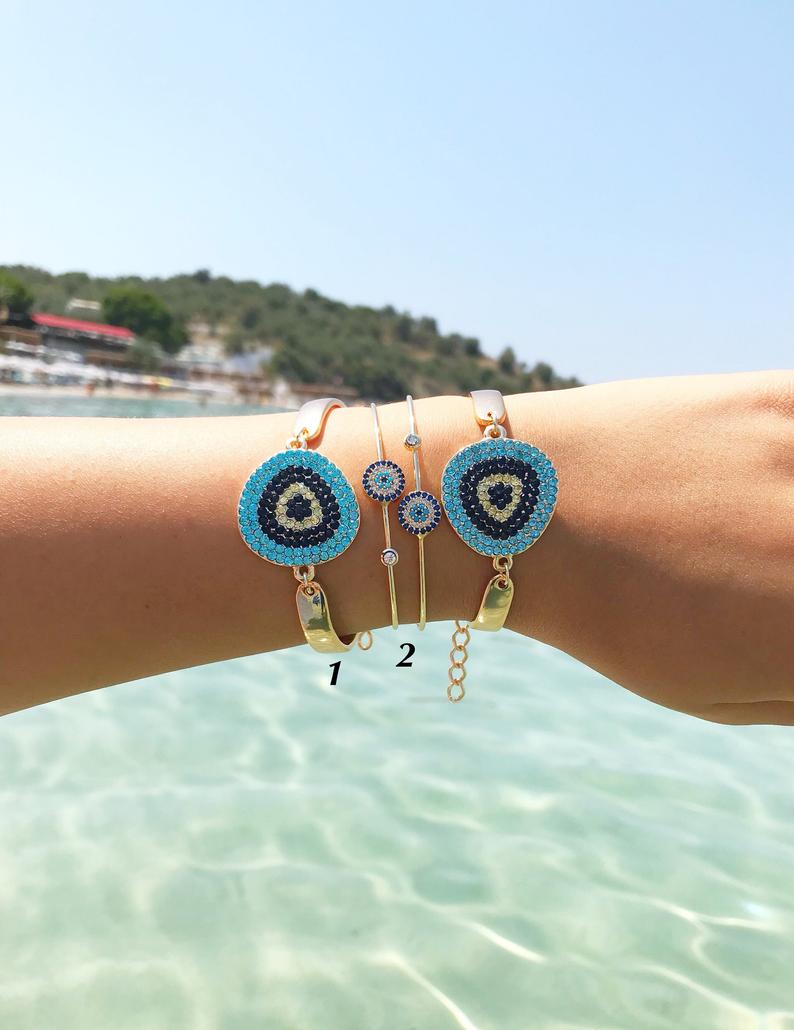 A beautiful Gold Evil Eye Bracelet Set featuring handmade zirconia and bangle designs, symbolizing protection and style.