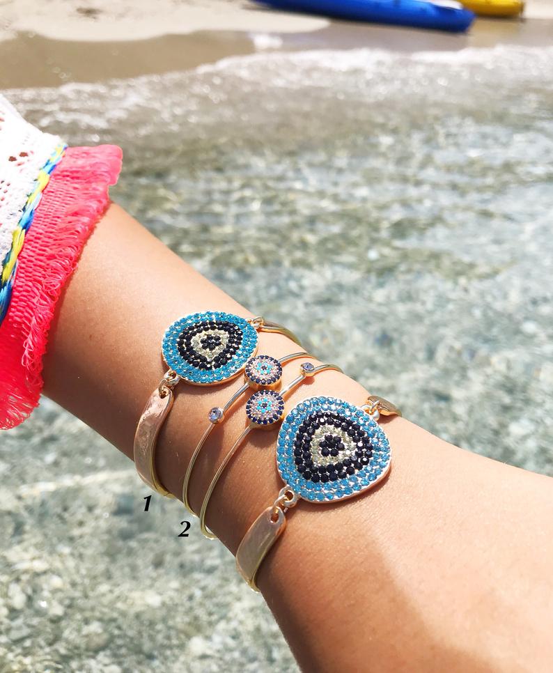 A beautiful Gold Evil Eye Bracelet Set featuring handmade zirconia and bangle designs, symbolizing protection and style.