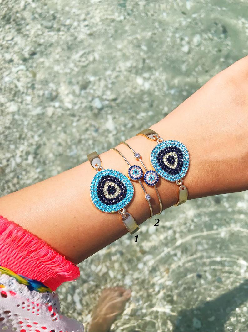 A beautiful Gold Evil Eye Bracelet Set featuring handmade zirconia and bangle designs, symbolizing protection and style.