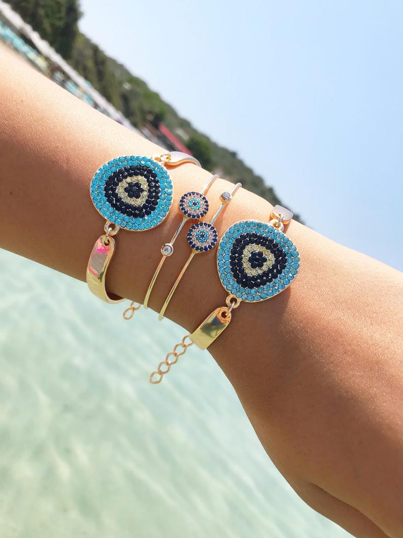 A beautiful Gold Evil Eye Bracelet Set featuring handmade zirconia and bangle designs, symbolizing protection and style.