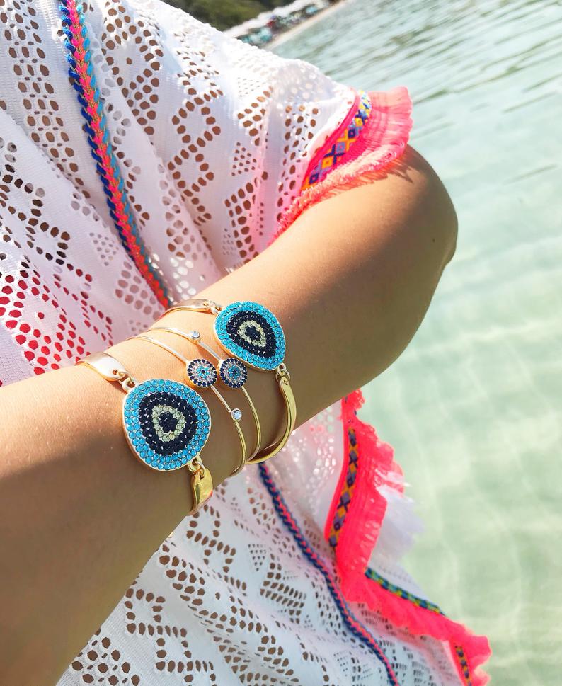 A beautiful Gold Evil Eye Bracelet Set featuring handmade zirconia and bangle designs, symbolizing protection and style.