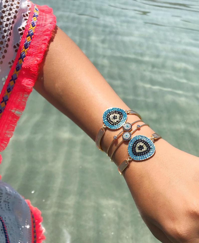 A beautiful Gold Evil Eye Bracelet Set featuring handmade zirconia and bangle designs, symbolizing protection and style.