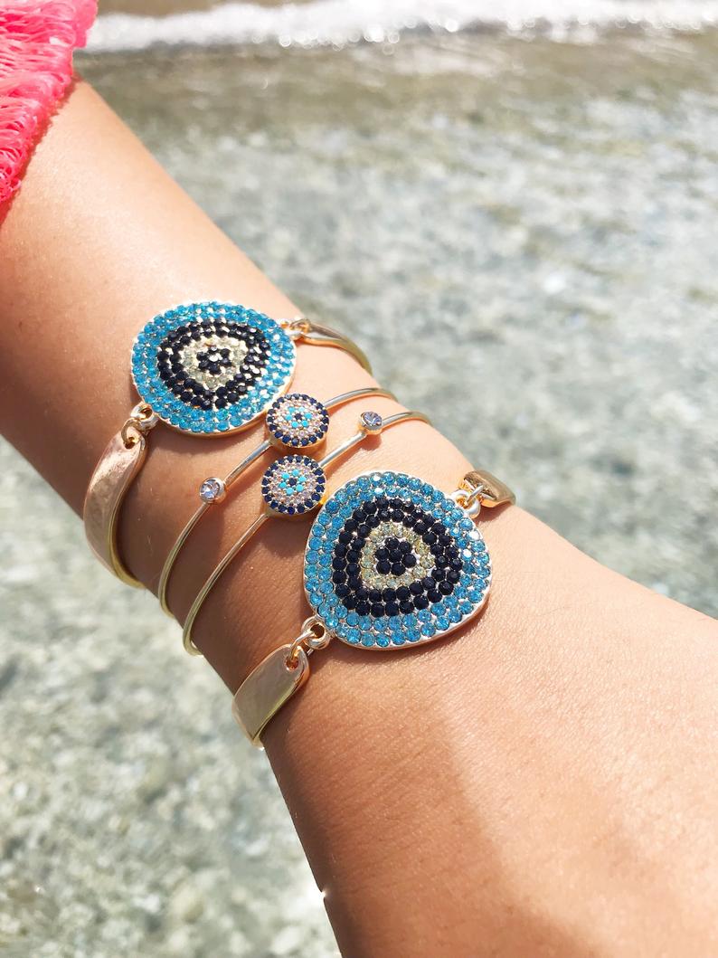 A beautiful Gold Evil Eye Bracelet Set featuring handmade zirconia and bangle designs, symbolizing protection and style.